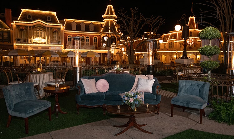 Armchairs and sofas are set up in front of Cinderella Castle in Magic Kingdom park