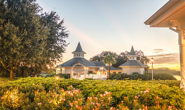 A garden of flowers and greenery surrounds Disney’s Wedding Pavilion