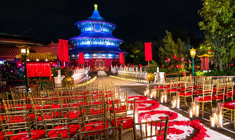 A wedding ceremony setting decorated with candles and an aisle of rose petals at the China Pavilion