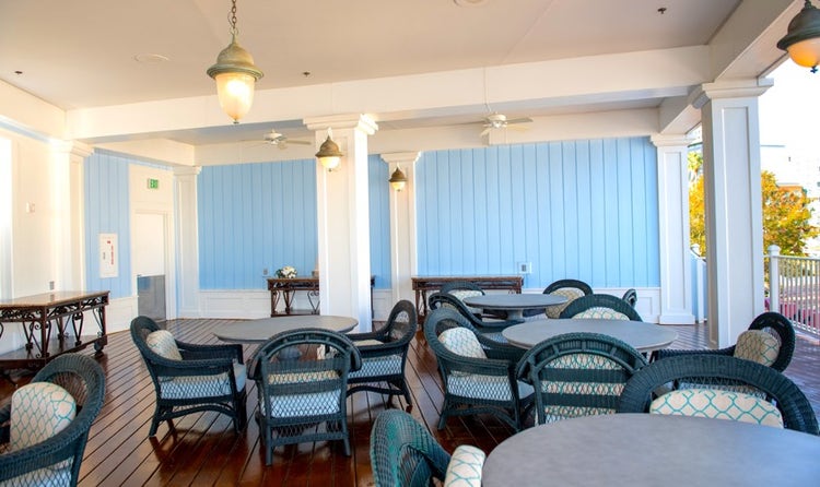 An outdoor seating area on a balcony overlooking Crescent Lake