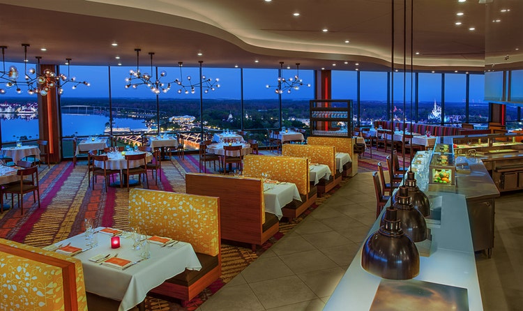 The dining room at California Grill in Disney’s Contemporary Resort with views of Magic Kingdom park and Seven Seas Lagoon