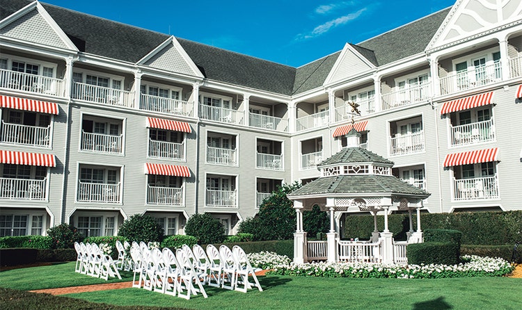A gazebo surrounded by flowers in an enclosed lawn at Disney's Yacht Club Resort