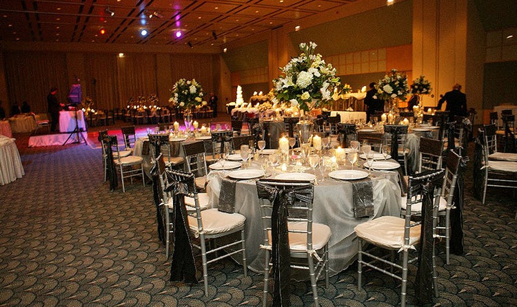 Several round tables with large floral centerpieces