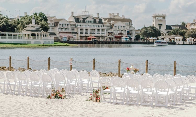 Several rows of chairs on a beach facing the water