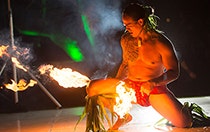 A man performing a Polynesian fire knife dance at a wedding reception