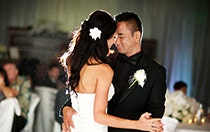 A newlywed bride and groom dancing together in a ballroom