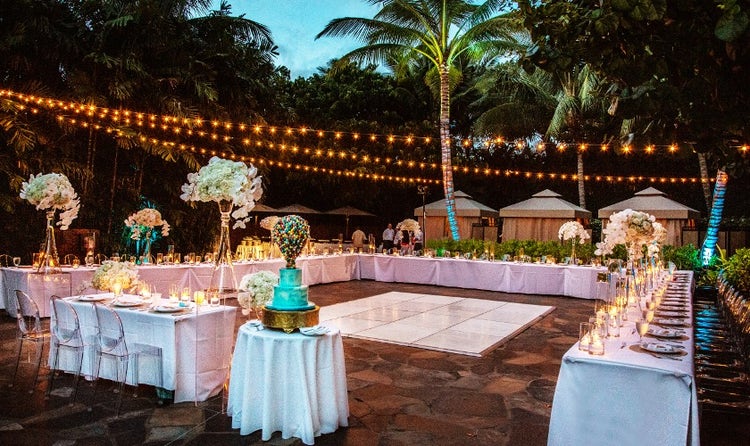 A table surrounding a dance floor at an outdoor venue in Aulani, A Disney Resort and Spa