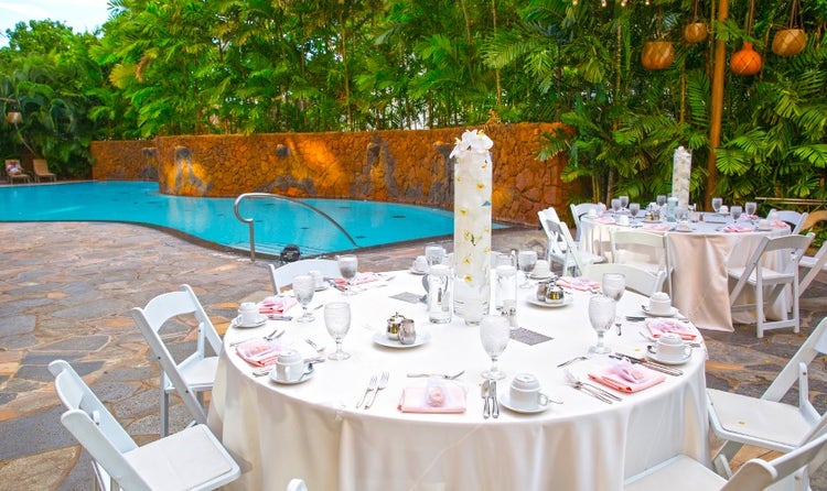 Tables and chairs set up alongside Wailana Pool at Aulani, A Disney Resort and Spa