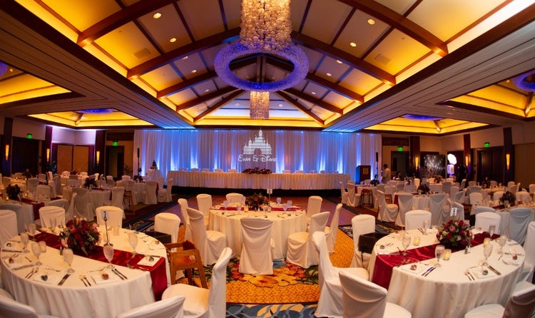 The spacious Kaiona Ballroom featuring tables and chairs around a dance floor