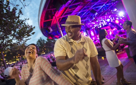 Two newlyweds dancing at an outdoor venue at Walt Disney World Resort