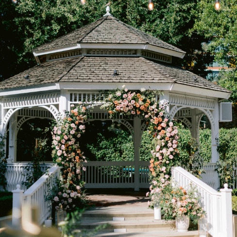 A wedding gazebo in Rose Court Garden decorated with floral arrangements