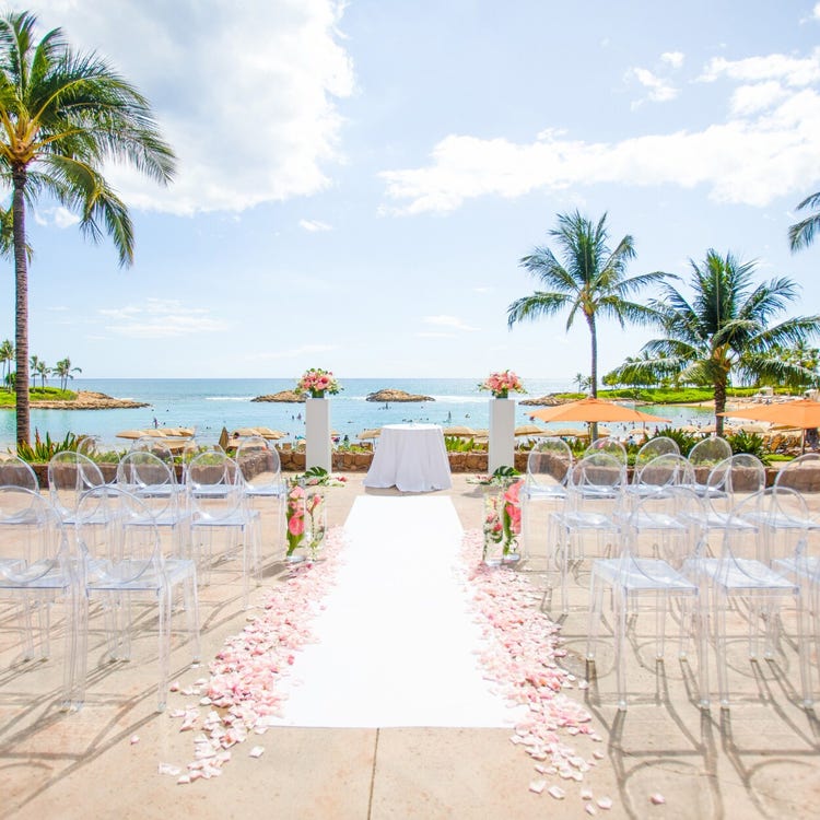 An outdoor wedding ceremony venue overlooking a tropical oceanfront