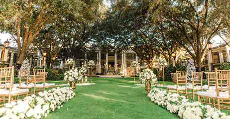 An outdoor wedding ceremony space surrounded by trees at Oak Manor Lawn in Disney's Port Orleans Resort, Riverside