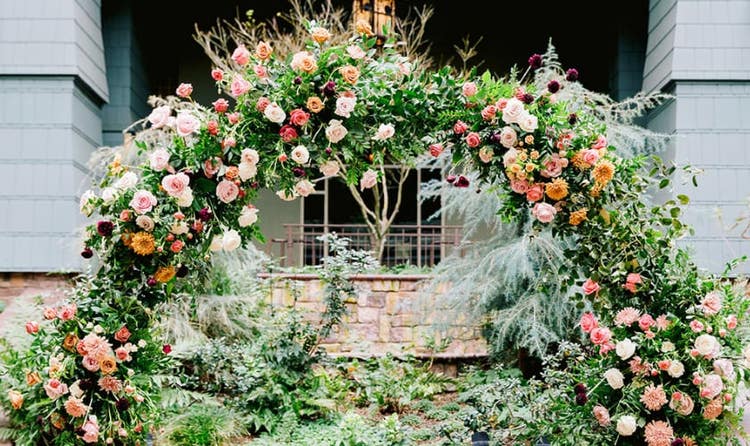 An outdoor wedding ceremony setup with a circular floral arch at Disney's Grand Californian Hotel and Spa