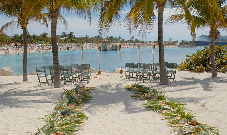 An aisle leading towards a wedding ceremony on a beach
