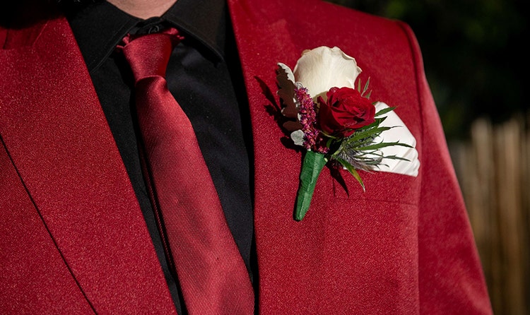 A groom wearing a rose boutonniere
