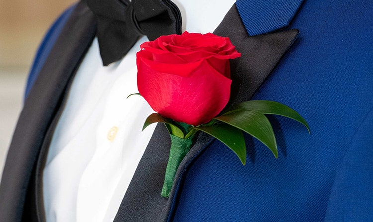 A groom wearing a rose boutonniere