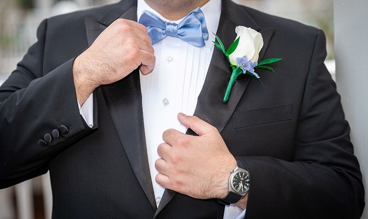 A groom wearing a rose boutonniere