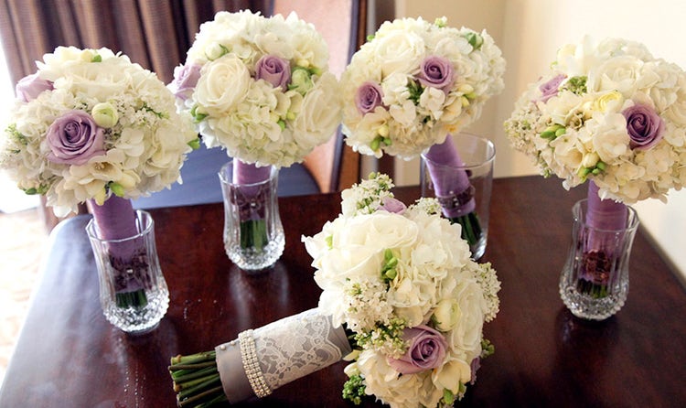 Purple rose, white rose and hydrangea bouquets with purple stem accents