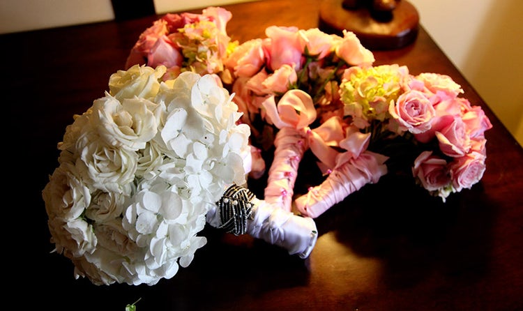 Whtie rose and hydrangea bridal bouquets with pink bridesmaids bouquets